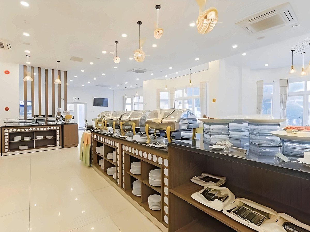 Buffet counter with trays of food and serving dishes in a bright restaurant